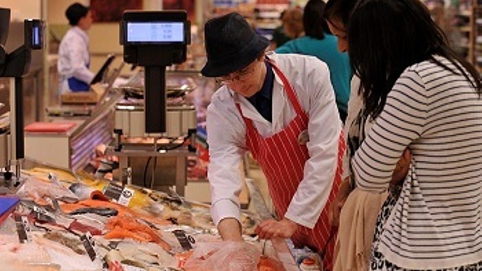 Un cliente en un puesto de frescos en un supermercado - 